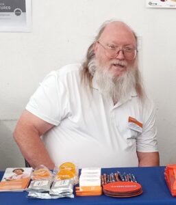 Man with a beard sitting at a table.